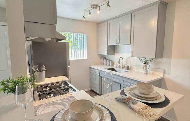 A kitchen with a white countertop and a black and white placemat.