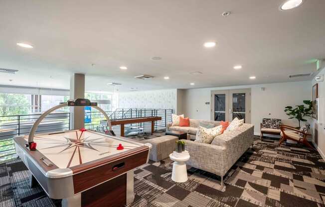 a game room with a pool table and couches