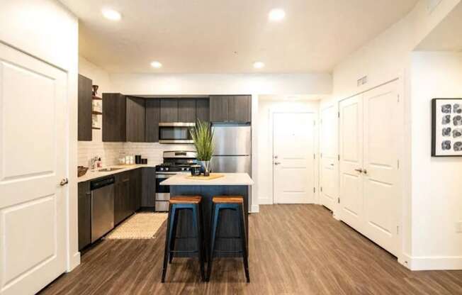 a kitchen with black and white cabinets and a counter top