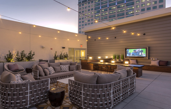 Outdoor lounge with seating and flatscreen TV