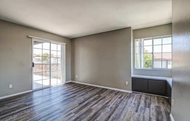 living room with wood flooring and a door to a balcony