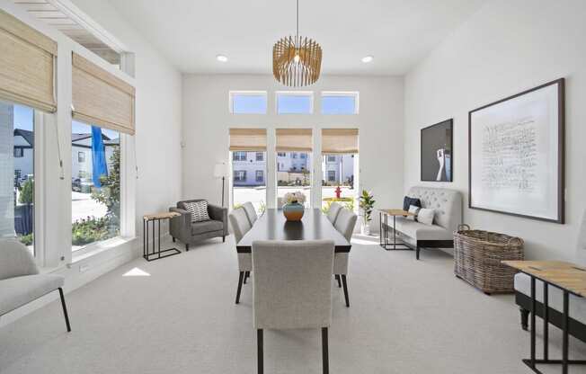 a dining room with a table and chairs and a large window
