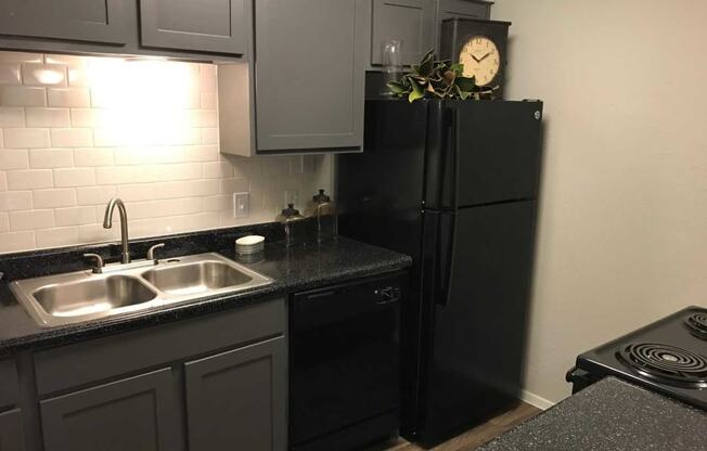 a kitchen with a sink and a refrigerator