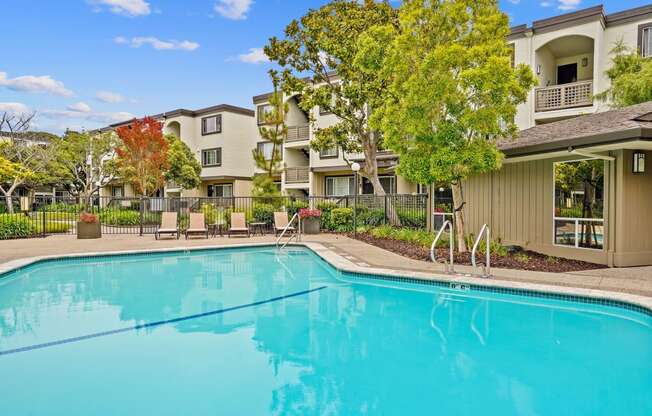 a swimming pool with a building in the background