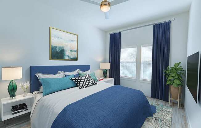 a blue and white bedroom with a bed and a ceiling fan