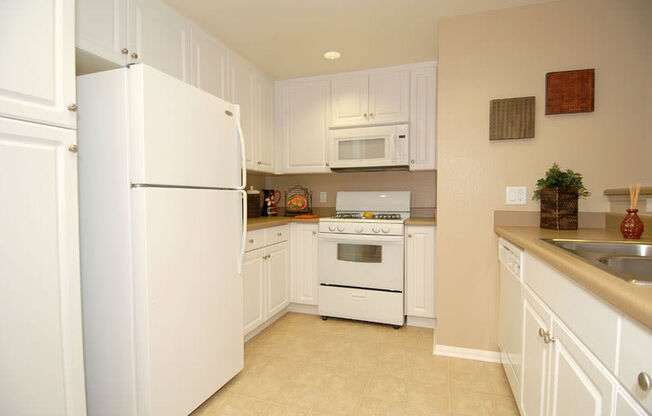 Kitchen with white cabinets and appliances