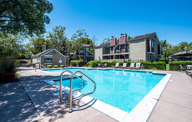 Apartments for Rent in Pittsburg - Kirker Creek - Pool Area with Tables, Lounge Chairs, Umbrellas, and Shed Area