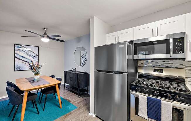 A modern kitchen with a dining table and chairs.