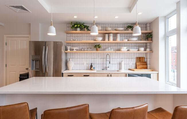 community entertaining kitchen with open shelving and a large white island