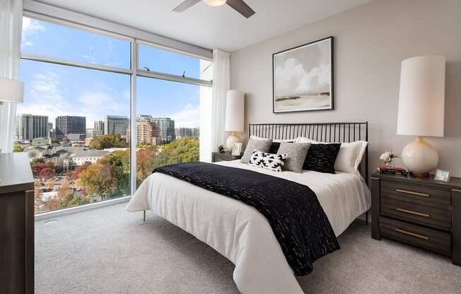 a bedroom with a bed and a view of the city