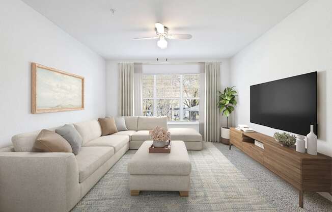 a living room with a large couch and a flat screen tv