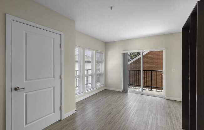 Apartment View of Living Area with sliding glass doors leading to a balcony at Sedona Apartments, Seattle