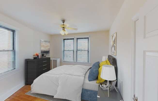 bedroom with bed, nighstands, dresser, large windows and ceiling fan at the klingle apartments in washignton dc