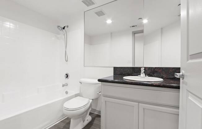 a white bathroom with a toilet and a sink