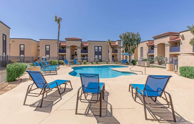 Apartments for rent in Phoenix, AZ - Monaco31 - Gated shimmering swimming pool with lounge, umbrella, table, and barbecue area