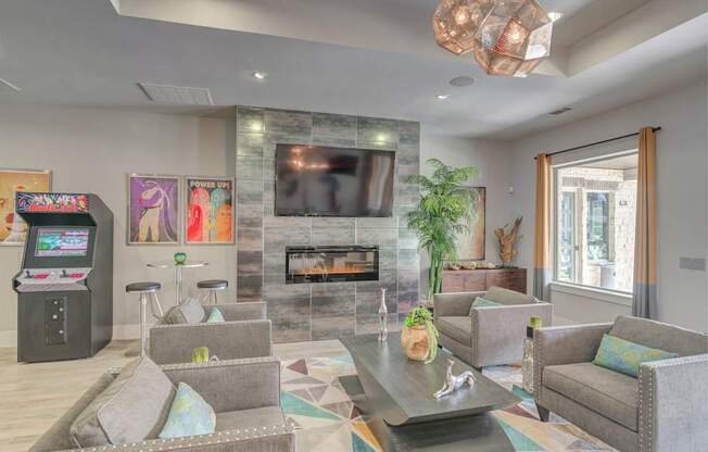 A modern living room with a fireplace and a television.