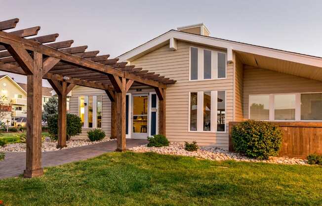 Elegant clubhouse exterior with arches and landscaping at Aurora Meadows apartments.