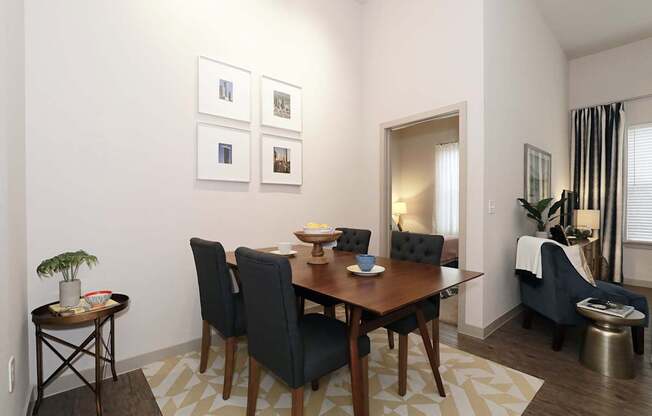 A dining room with a table set for four.