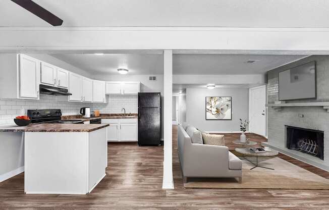 Pet-Friendly Apartments in Overland Park– Treetop Lodge – A modern kitchen with white cabinets and a black refrigerator.