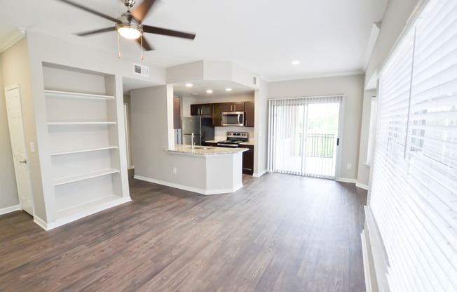 Beautiful upgraded kitchen with stainless steel appliances, granite countertops and walnut brown cabinetry, large open floorplan with built in bookshelf located at The Legends at Eagle Mountain Lake -A beautiful lakeside community.