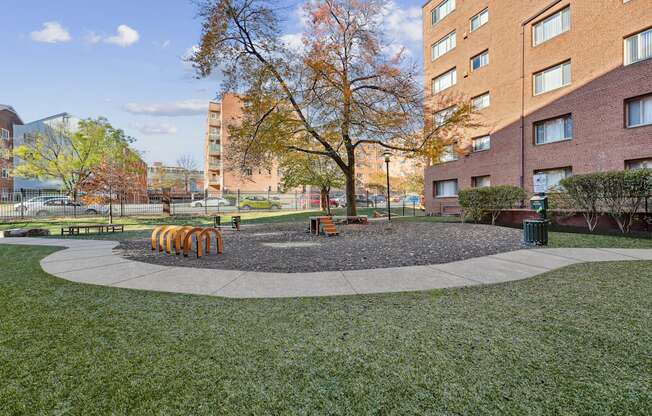 A tree in a circle of gravel is the focal point of a courtyard.