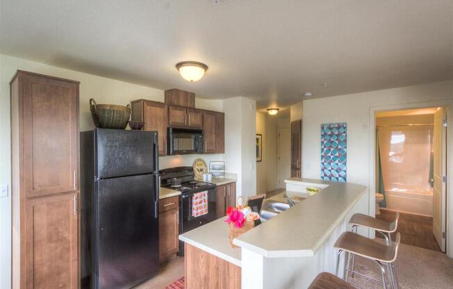 Kitchen with breakfast countertop | Urban Center apartments in Lynnwood