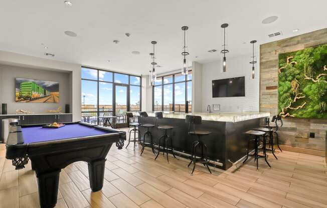 a large room with a pool table and a bar