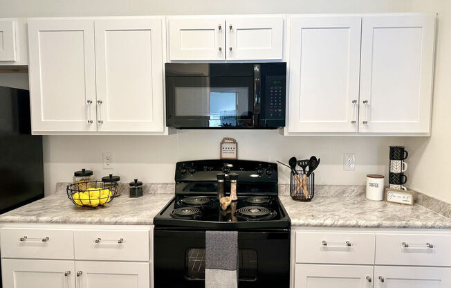 A black stove top oven with a towel on it.