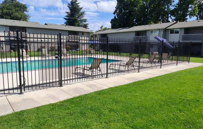 a swimming pool with a wrought iron fence around it