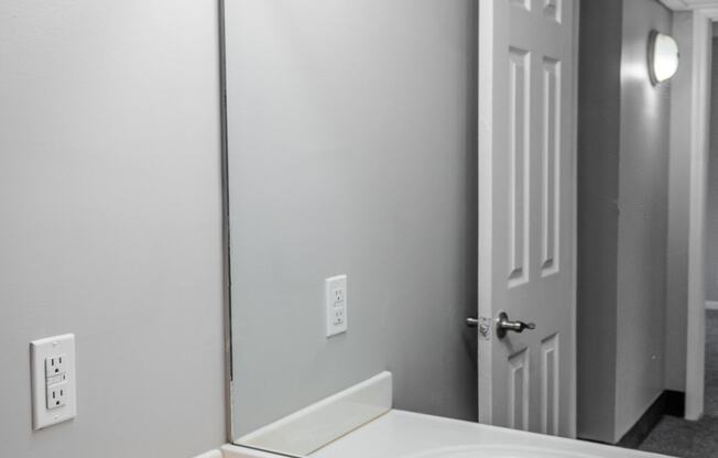 an empty bathroom with a sink and a mirror