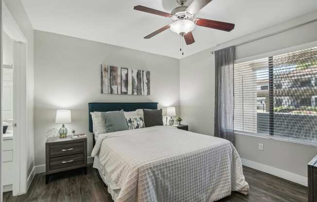 a bedroom with a bed and a ceiling fan