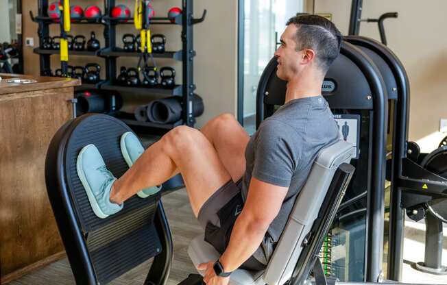 a man working out on a machine in a gym