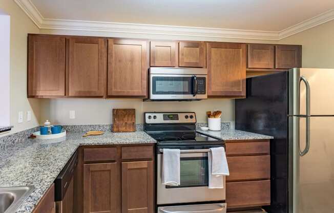 a kitchen with stainless steel appliances and granite counter tops