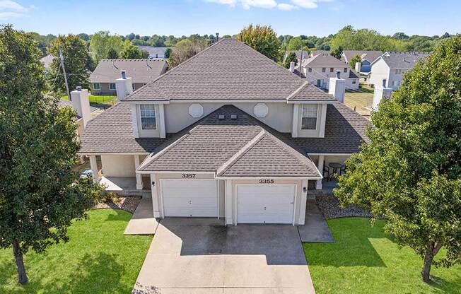 a house with a garage and a yard with trees