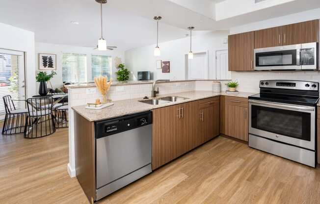 a large kitchen with stainless steel appliances and wooden cabinets