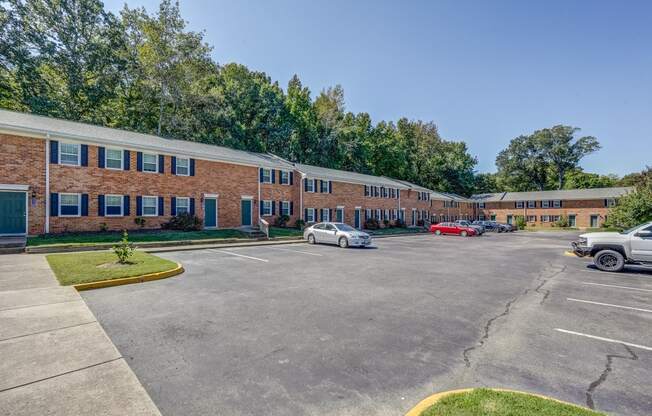 an empty parking lot in front of a brick building