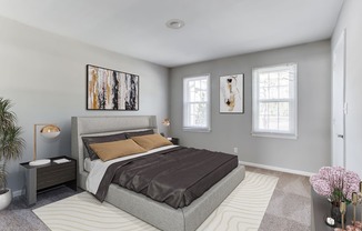 a bedroom with grey walls and a gray bed