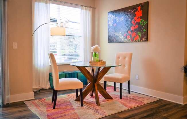 a dining room with a table and two chairs