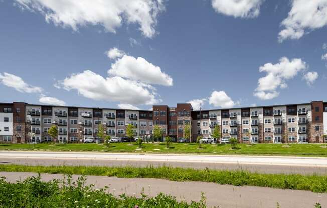 an exterior view of an apartment building on a sunny day