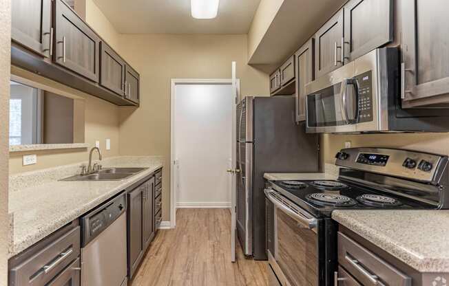 This unit boasts a spacious, freshly renovated kitchen complete with sleek stainless steel appliances.