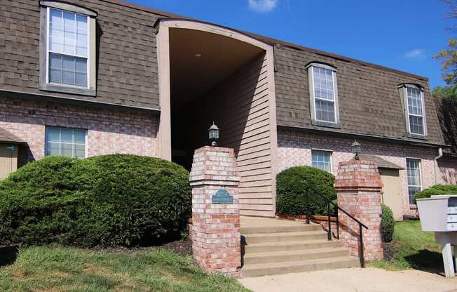 A house with a brown roof and a white mailbox.