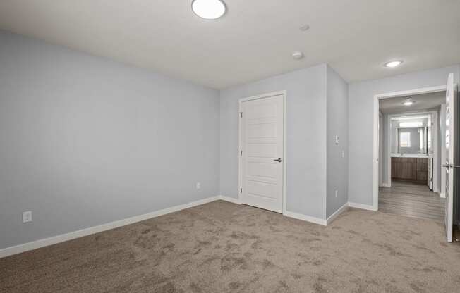 bedroom with closet door and view of the bathroom