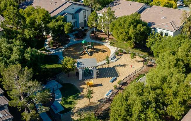 an aerial view of a playground in a neighborhood with houses
