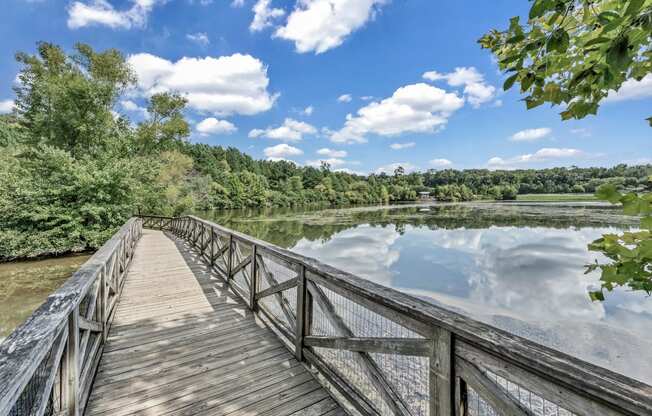 a wooden bridge over a body of water with trees