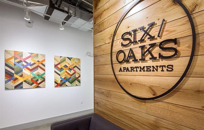 a wall with a logo of six oaks apartments on it