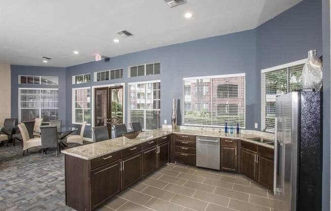 a large kitchen with a sink and a refrigerator at Veranda at Centerfield, Houston