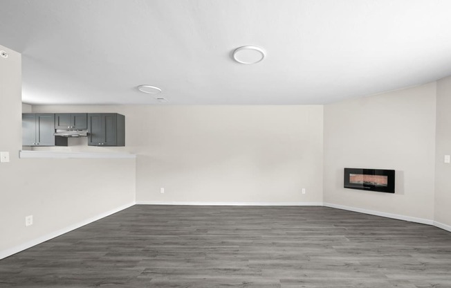 an empty living room with white walls and a fireplace at Diamond Ridge Townhomes, Oklahoma ,73114