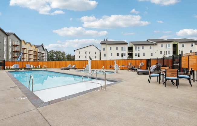 our apartments have a resort style pool with chairs and tables