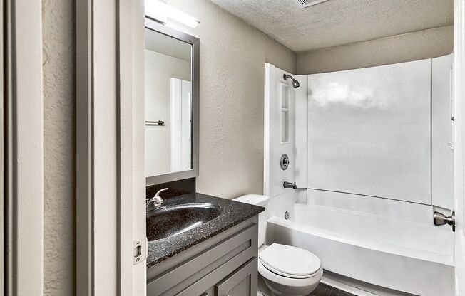 a bathroom with a sink toilet and bathtub