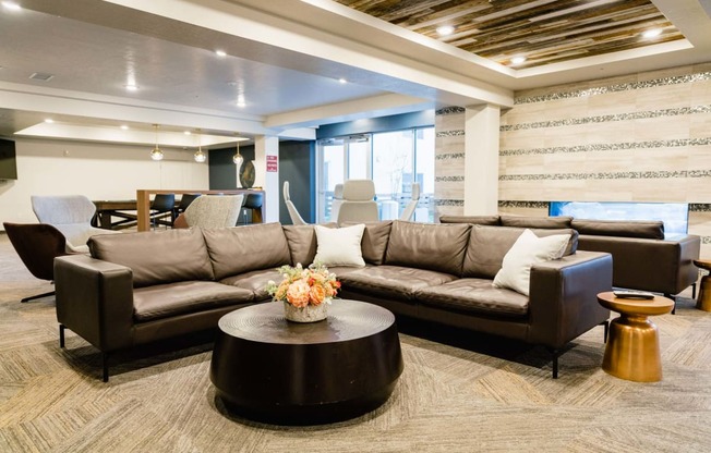 a lobby with couches and chairs and a table in a downtown Salt lake City apartment community